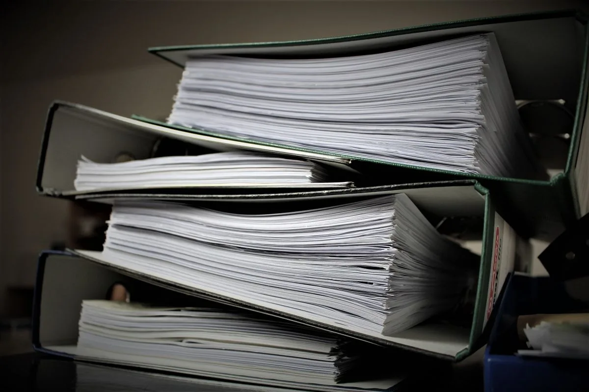 Binders and paperwork, illustrating removing a known password from a PDF you own
