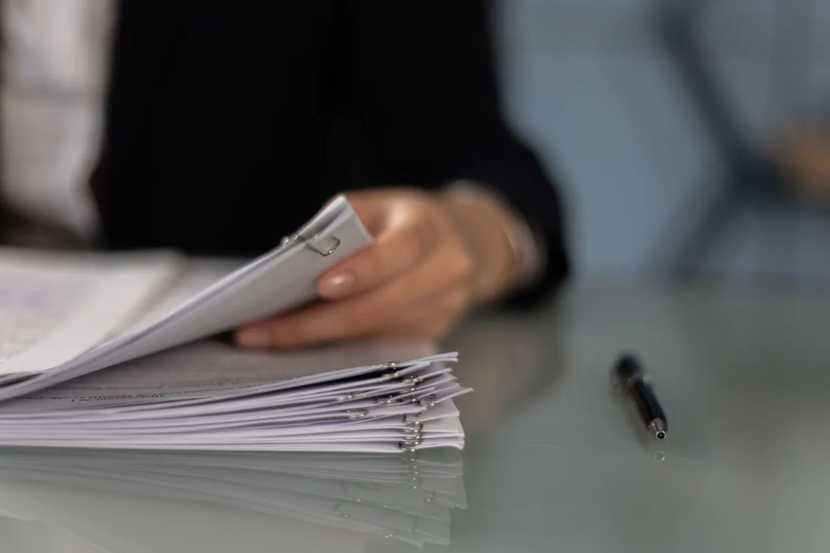 Scanned paperwork being organised, illustrating how OCR makes a scanned PDF searchable